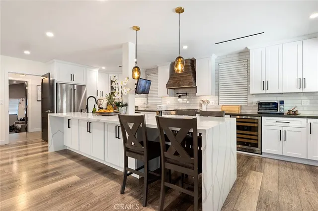 a kitchen with appliances a sink and cabinets