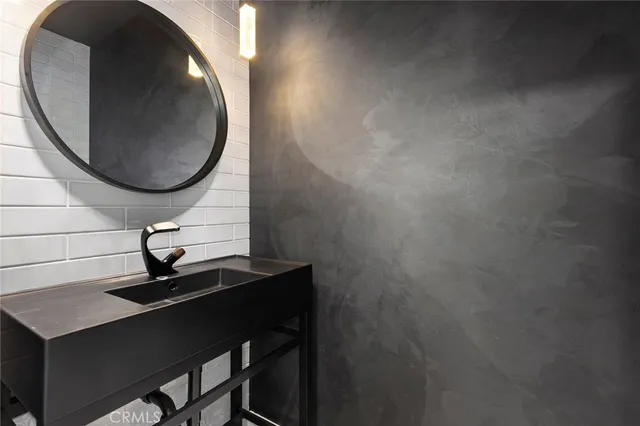 a bathroom with a double vanity sink toilet and shower