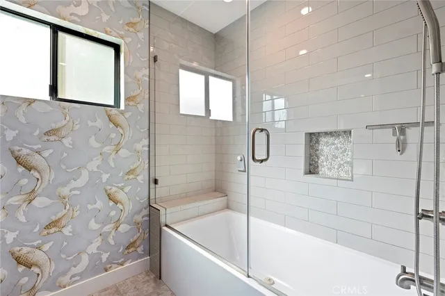 a bathroom with a bathtub and a shower