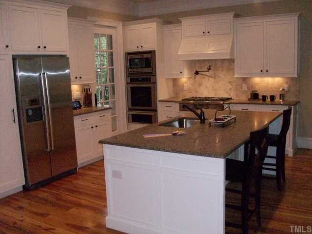 2630 Davis Street Raleigh, NC 27608 - Photo 5 of 12 This has been many people's favorite room of the house! Some features here are the custom made cabinets w/ beaded inset doors, soft-close drawers, pot filler faucet, honed-finish granite, seating for four, pantry cabinet, and more...