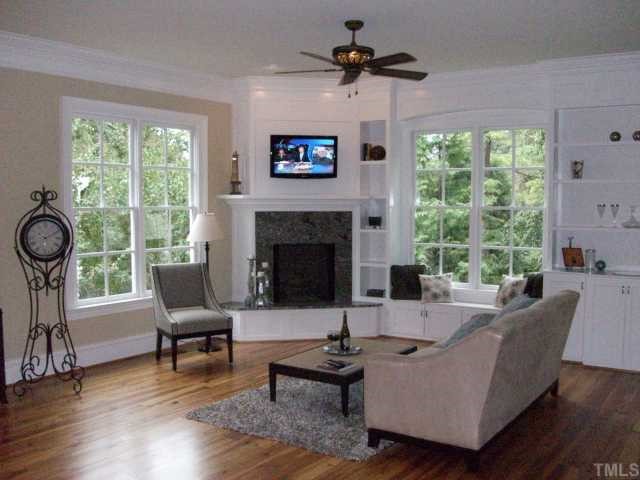 2630 Davis Street Raleigh, NC 27608 - Photo 6 of 12 This is the family room where you can see the fireplace with custom granite surround, wall to wall built-in's and window seat cabinets, and you can get a good look at the RECLAIMED HEART PINE floors, which are also throughout the first floor.