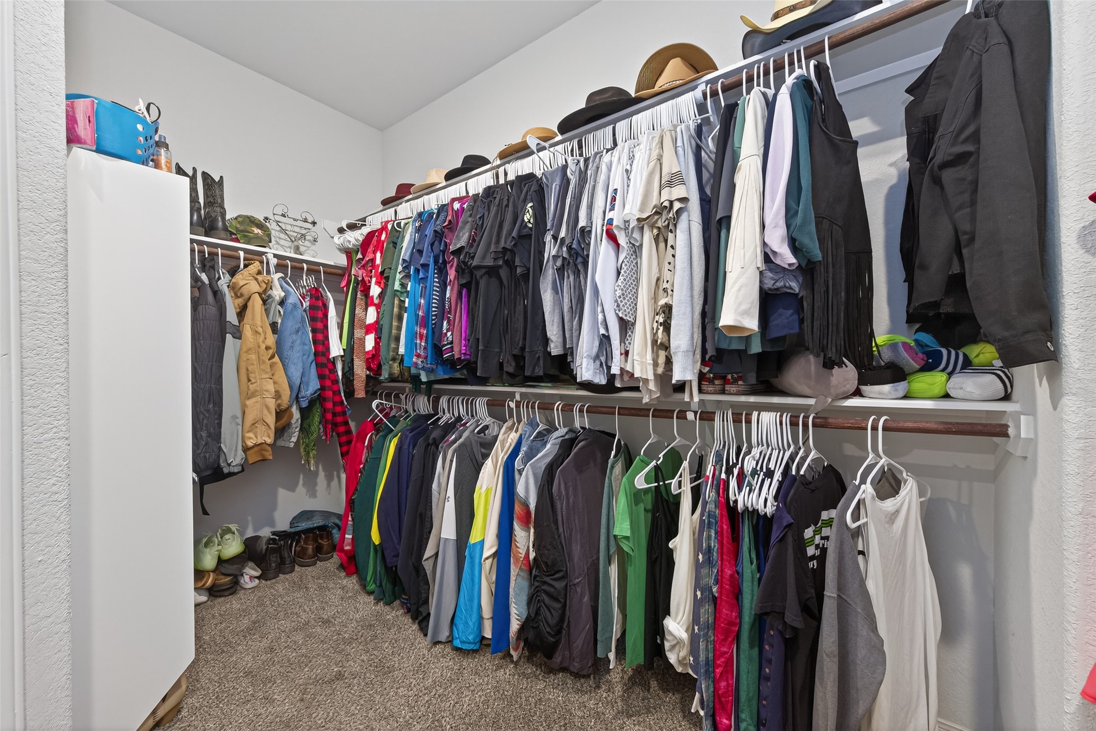 16601 Crosby Street Conroe, TX 77303 - Photo 26 of 50 Large walk-in closet with double hanging rods and ample shelving, offering plenty of storage and organization space.