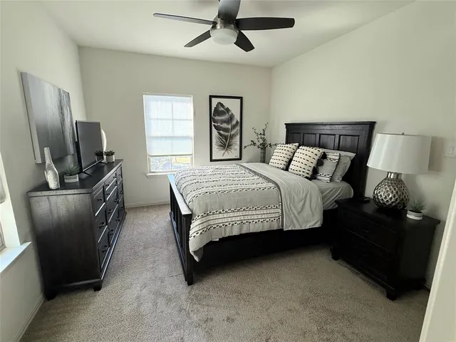 a bedroom with a bed and dresser