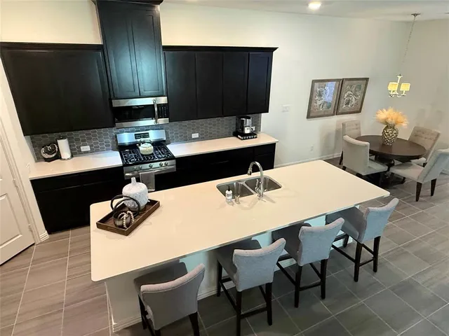 a kitchen with a dining table and chairs