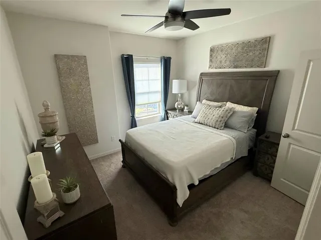 a bedroom with a bed a window and dresser