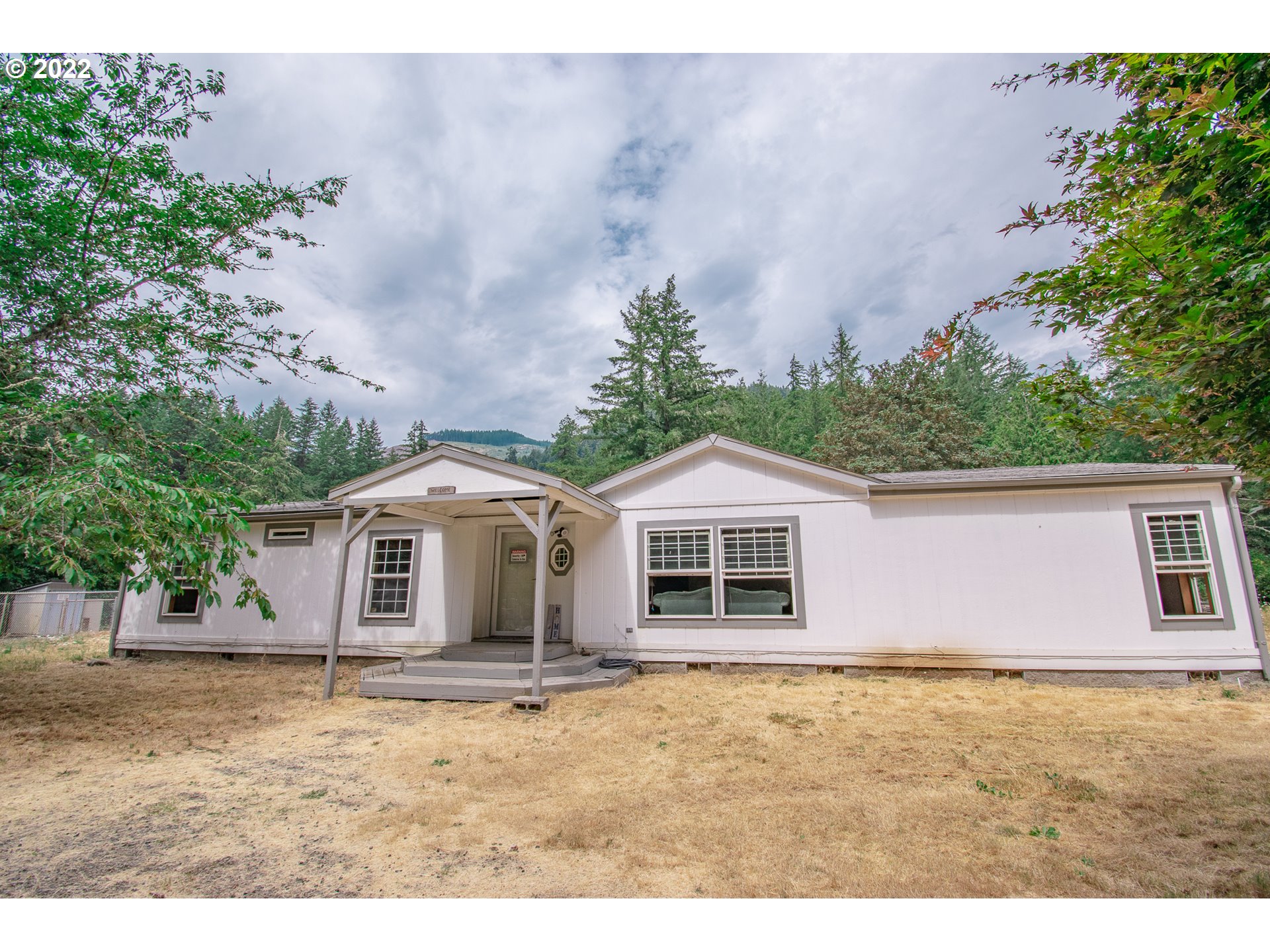 38435 Row River Road Dorena, OR 97434 - Photo 1 of 32 a house with trees in the background