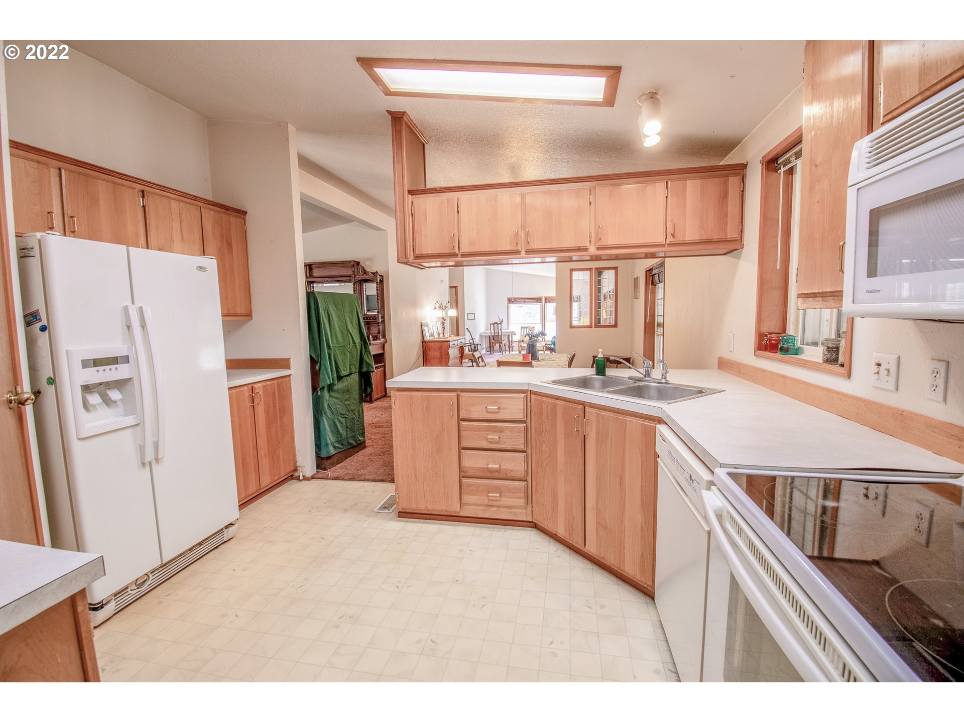 38435 Row River Road Dorena, OR 97434 - Photo 12 of 32 a kitchen with a refrigerator a sink and cabinets