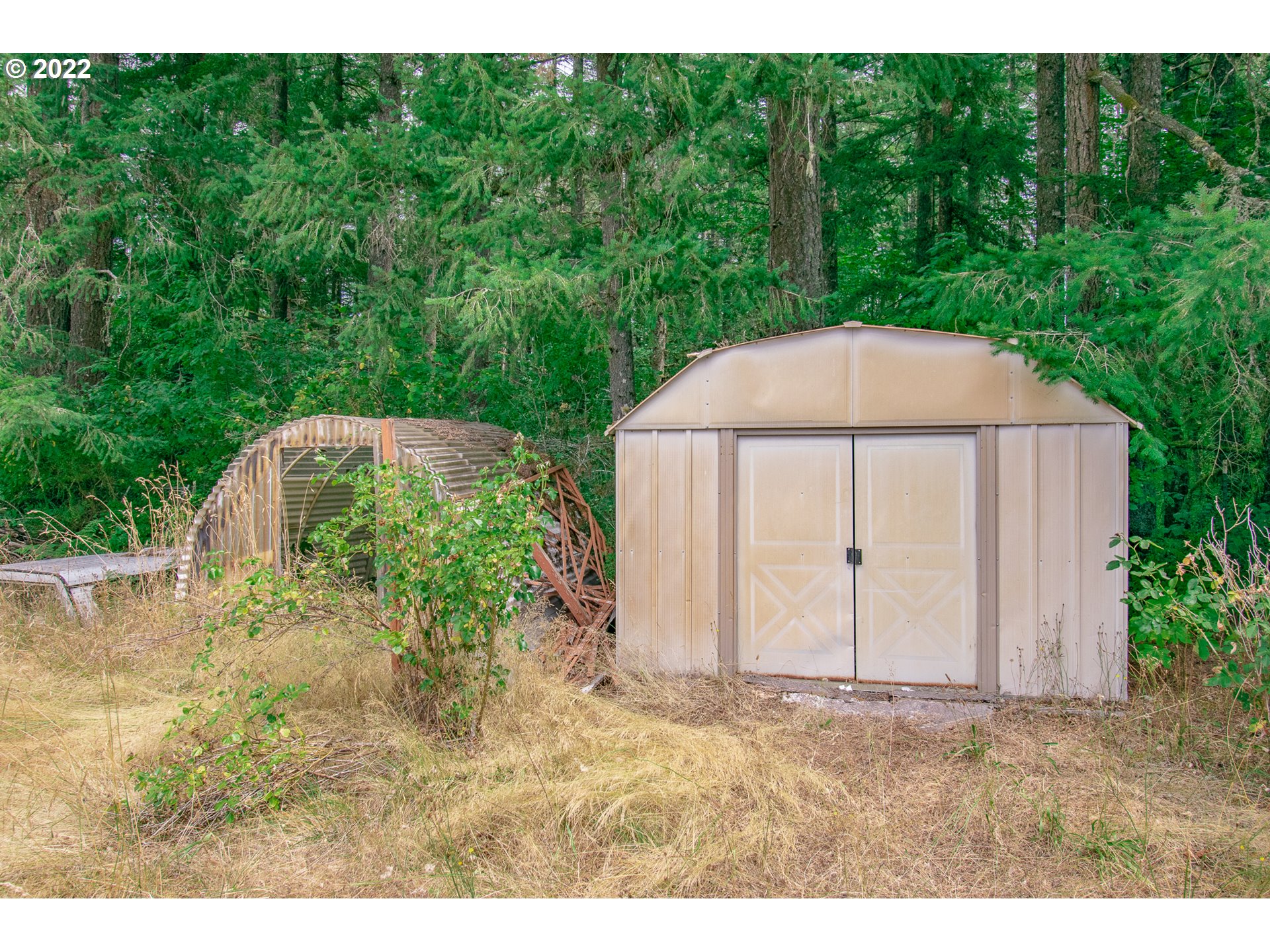 38435 Row River Road Dorena, OR 97434 - Photo 21 of 32 a backyard of a house with yard and trampoline