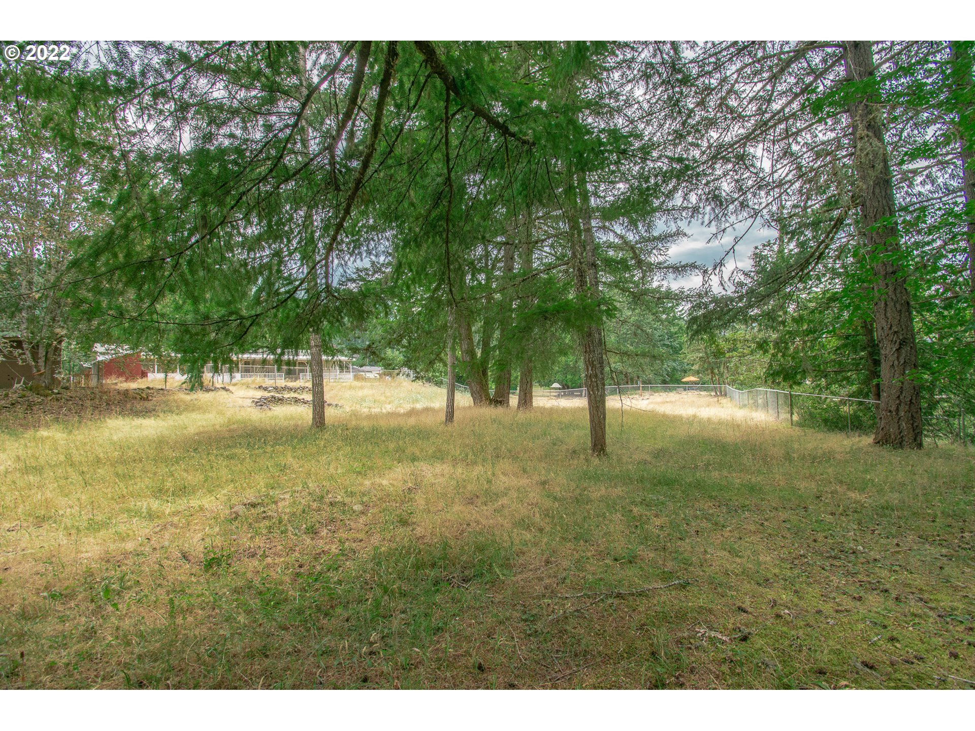 38435 Row River Road Dorena, OR 97434 - Photo 24 of 32 a view of dirt field with trees in the background