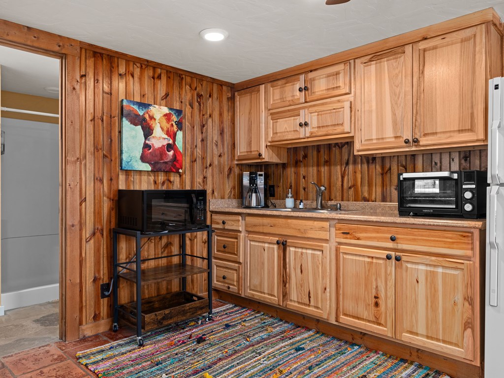 196 Hermit Hill Road Fredericksburg, TX 78624 - Photo 16 of 49 a kitchen with stainless steel appliances granite countertop a refrigerator and a sink
