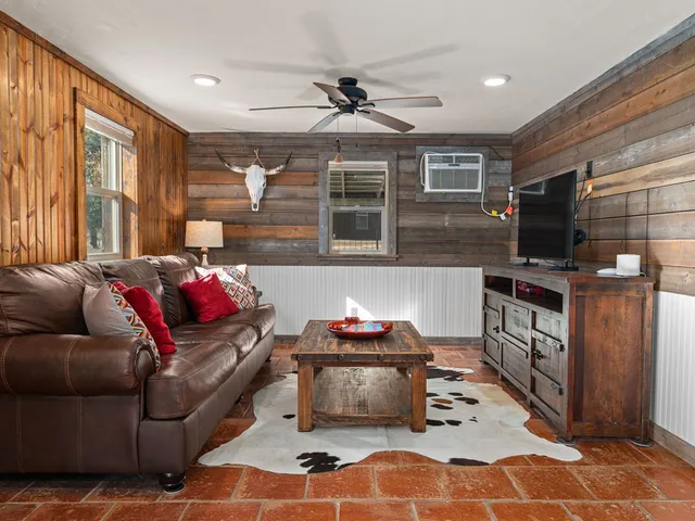a living room with furniture and a flat screen tv