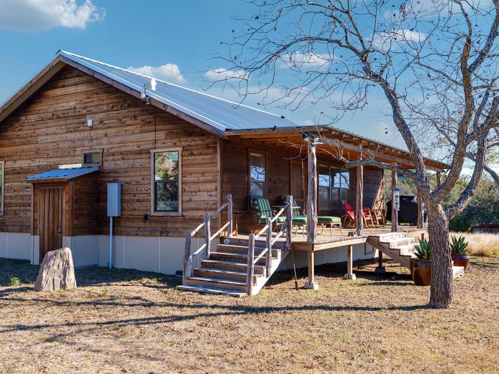 196 Hermit Hill Road Fredericksburg, TX 78624 - Photo 2 of 49 a view of a house with backyard and porch
