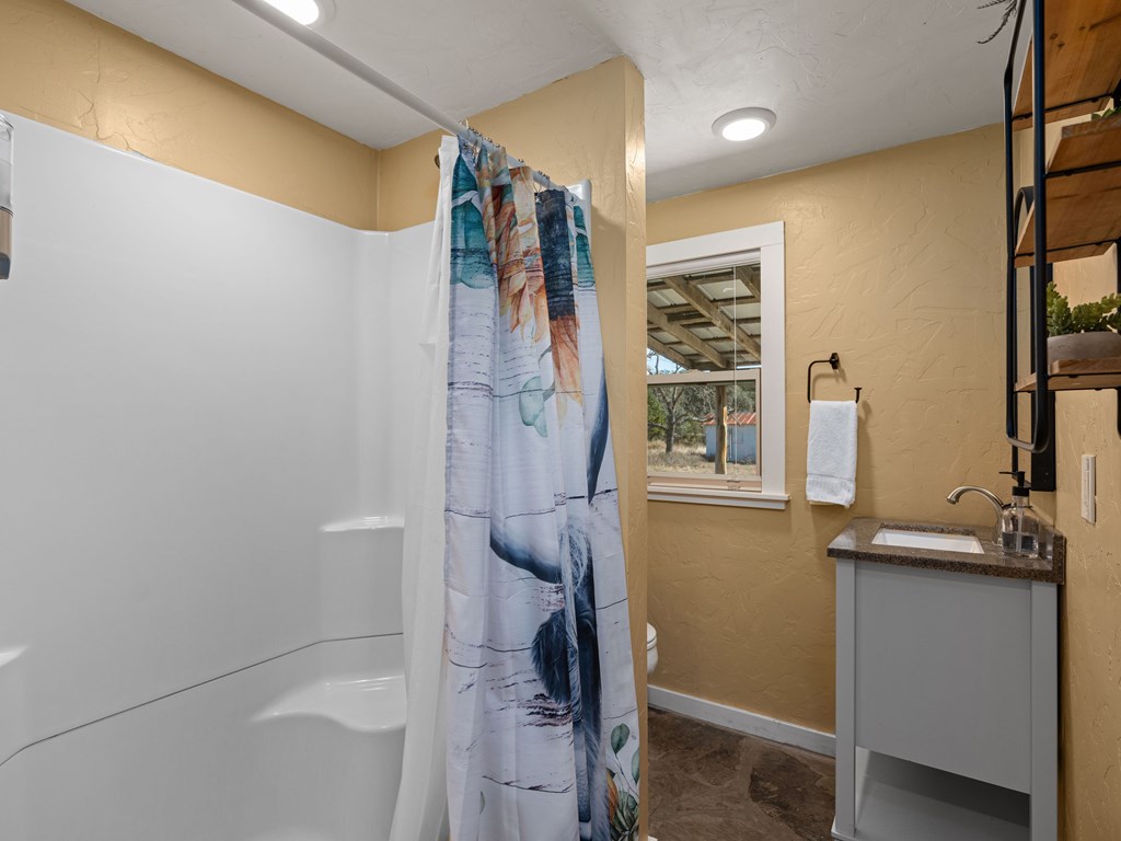 196 Hermit Hill Road Fredericksburg, TX 78624 - Photo 21 of 49 a bathroom with a sink and mirror