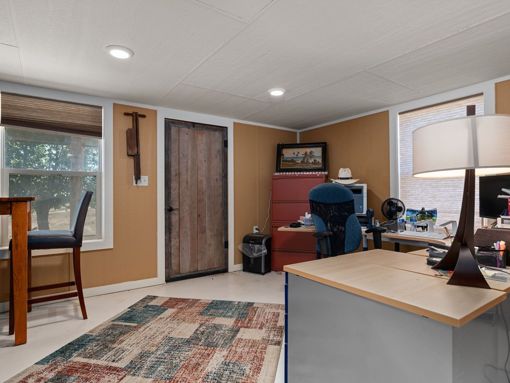 196 Hermit Hill Road Fredericksburg, TX 78624 - Photo 26 of 49 a room with furniture a window and a potted plant