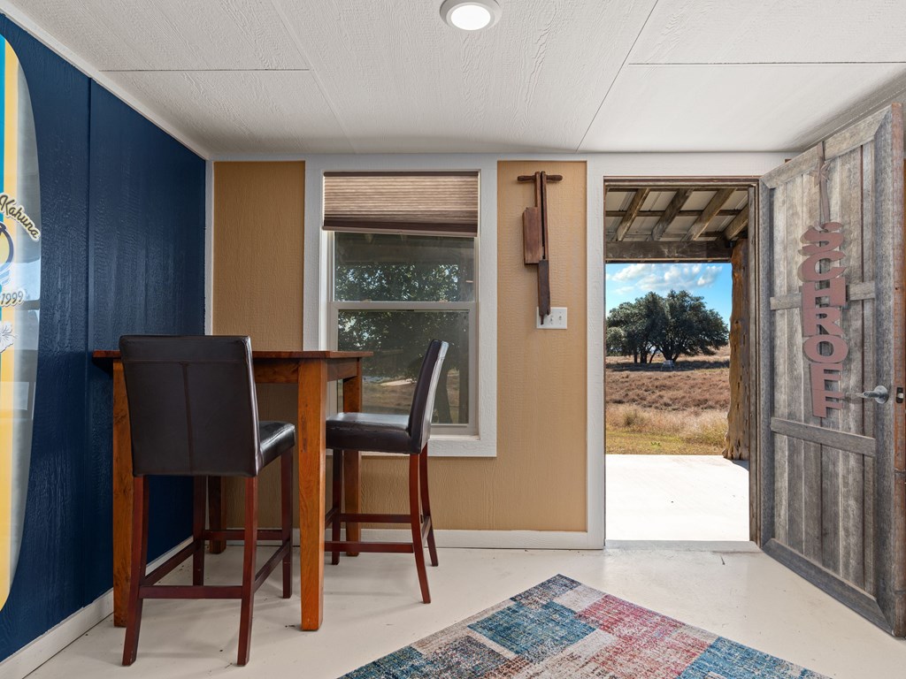 196 Hermit Hill Road Fredericksburg, TX 78624 - Photo 27 of 49 a view of a workspace with furniture and a window