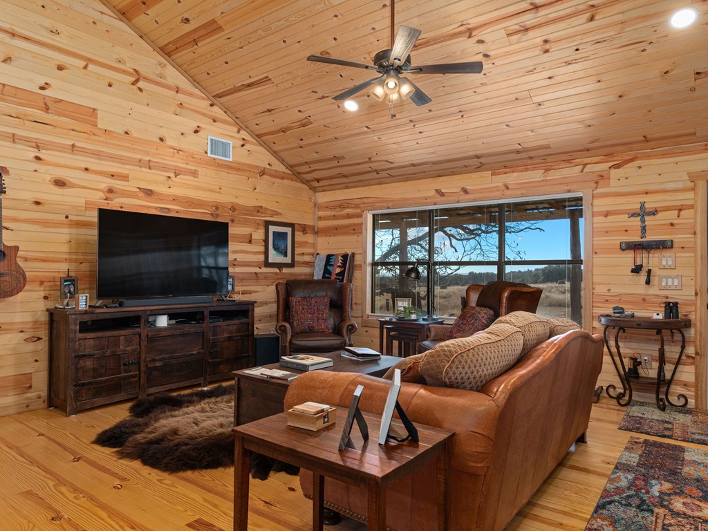 196 Hermit Hill Road Fredericksburg, TX 78624 - Photo 3 of 49 a living room with furniture and a flat screen tv
