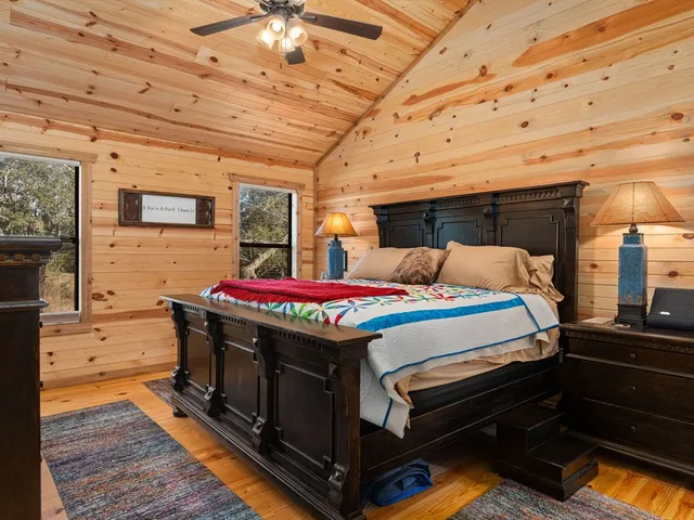 a bedroom with furniture and wooden floor