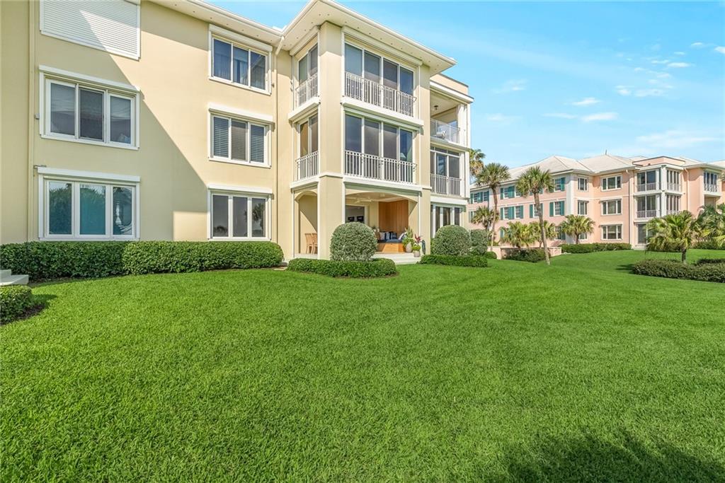 850 Beach Road, Unit 176 Indian River Shores, FL 32963 - Photo 18 of 18 a front view of a building and yard with green space