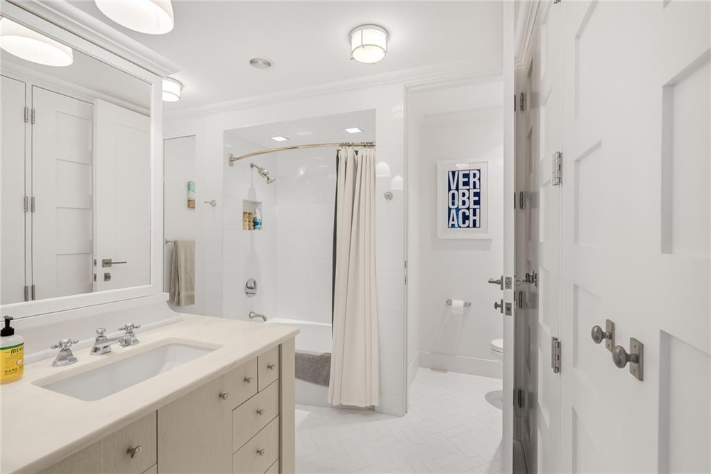 850 Beach Road, Unit 176 Indian River Shores, FL 32963 - Photo 8 of 18 a bathroom with a double vanity sink mirror and shower