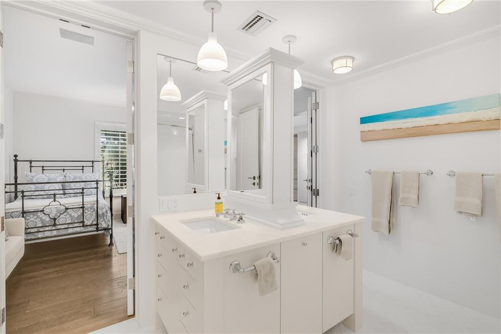 850 Beach Road, Unit 176 Indian River Shores, FL 32963 - Photo 9 of 18 a bathroom with a sink a mirror and a shower