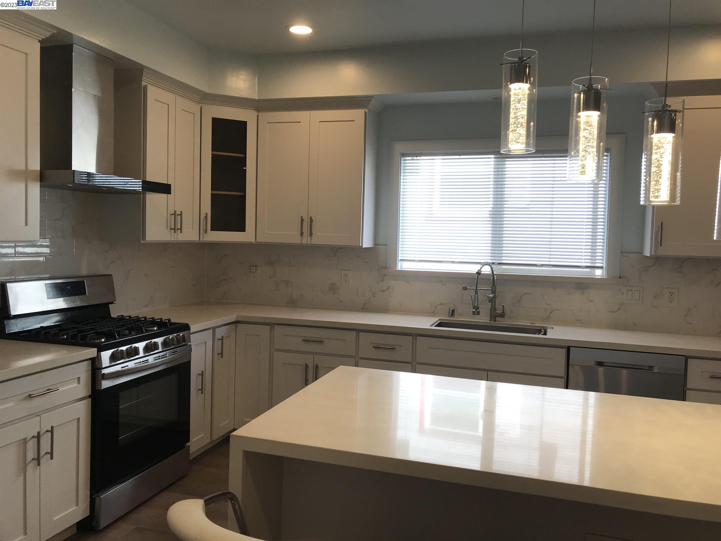 a kitchen with a sink a stove and cabinets