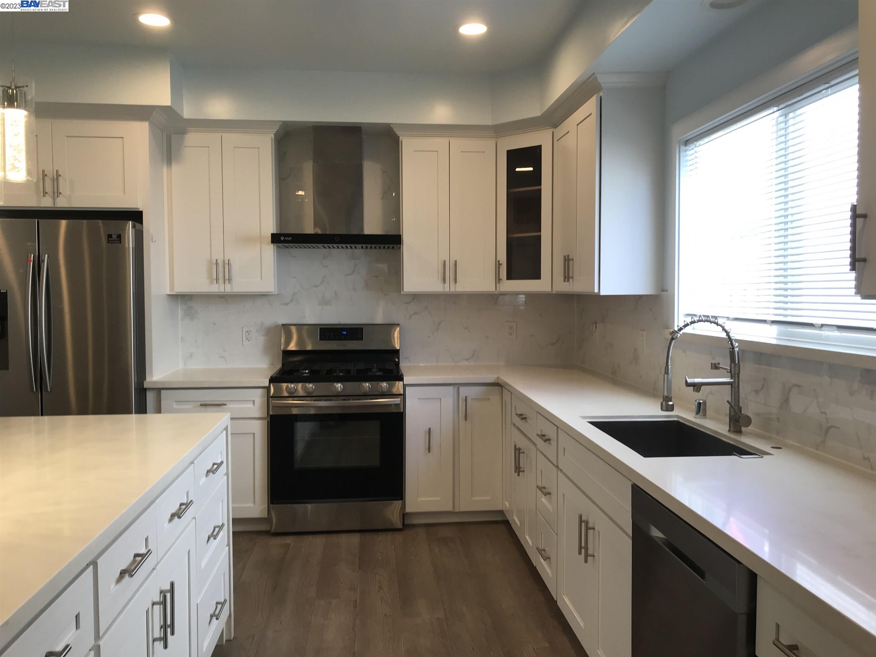 Southwest Berkeley Berkeley, CA 94702 - Photo 2 of 6 a kitchen with a sink stove and refrigerator