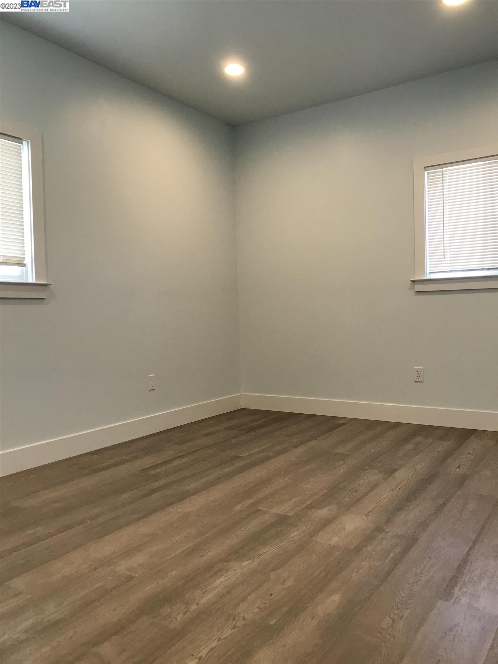Southwest Berkeley Berkeley, CA 94702 - Photo 3 of 6 a view of an empty room with wooden floor and a window