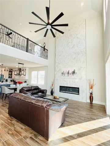 a living room with stainless steel appliances kitchen island granite countertop a stove a sink and a refrigerator