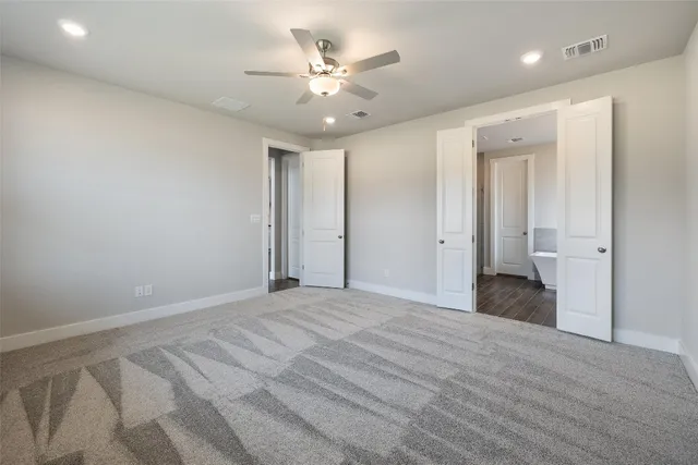 wooden floor in an empty room with a bathroom
