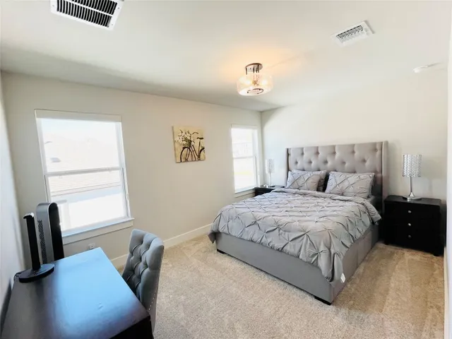 a bedroom with a bed and window