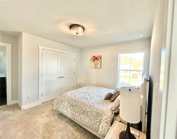 a bedroom with a bed and a window