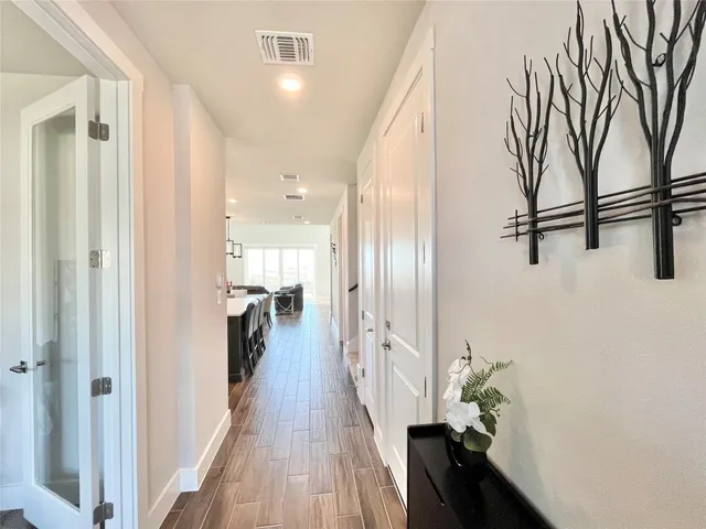a view of hallway with wooden floor and stairs
