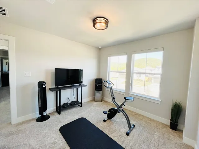 a view of a livingroom with workspace and a window