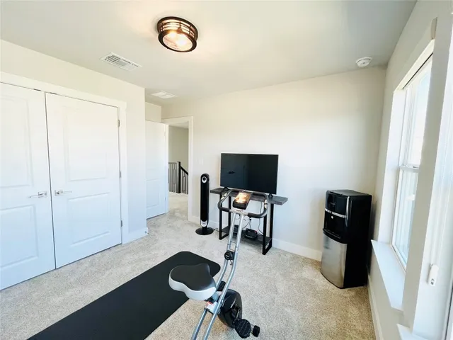 a view of a livingroom with entryway and furniture