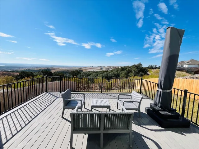 a view of a balcony with wooden floor and outdoor space