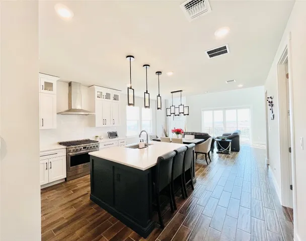 a kitchen with a sink stove and cabinets