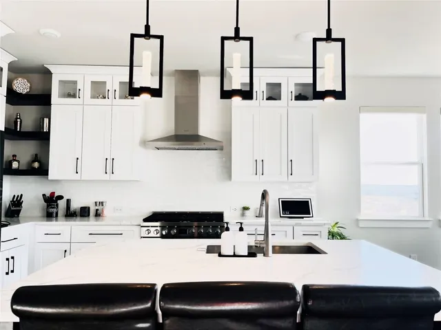 a kitchen with stainless steel appliances a sink and a refrigerator
