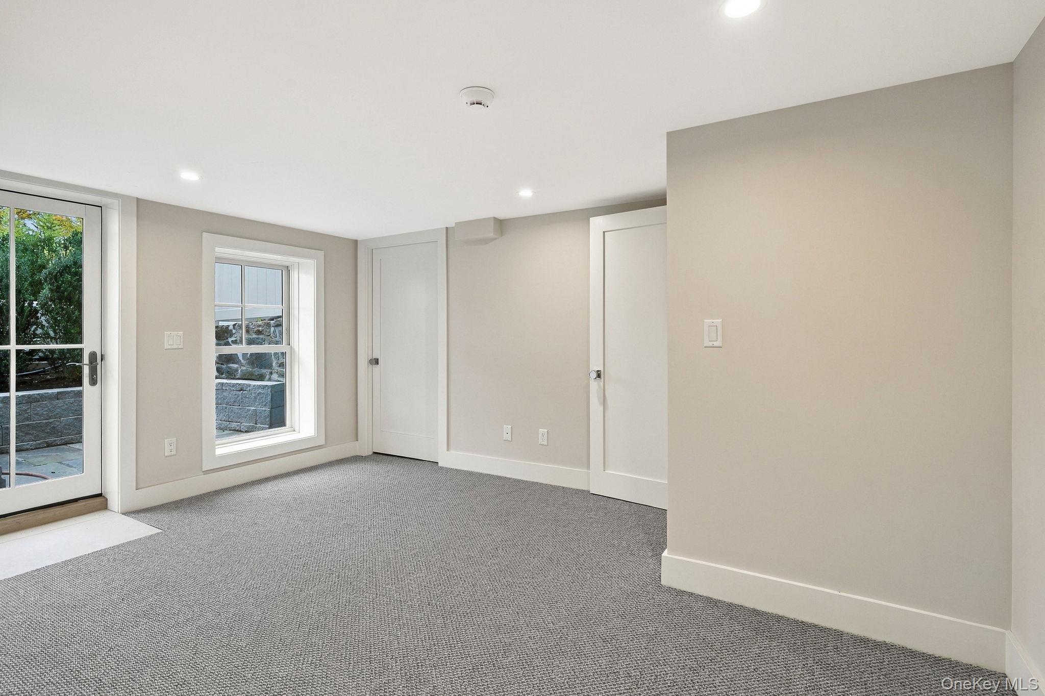 72 Orchard Avenue Rye, NY 10580 - Photo 31 of 40 lower level bedroom walk-out to patio