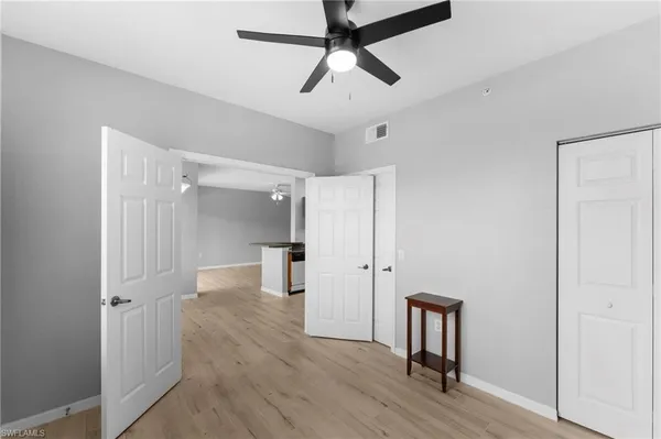 a view of empty room with wooden floor