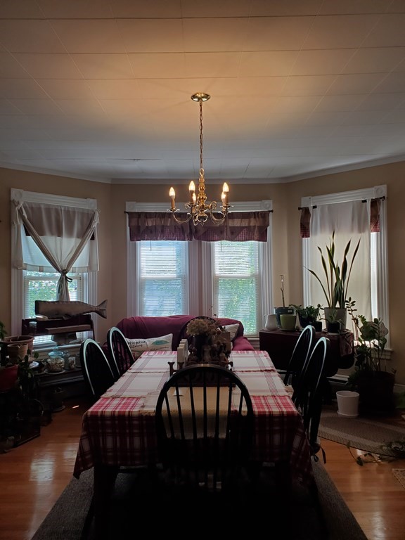 20 Baker Street Gardner, MA 01440 - Photo 13 of 15 a bedroom with furniture and a chandelier