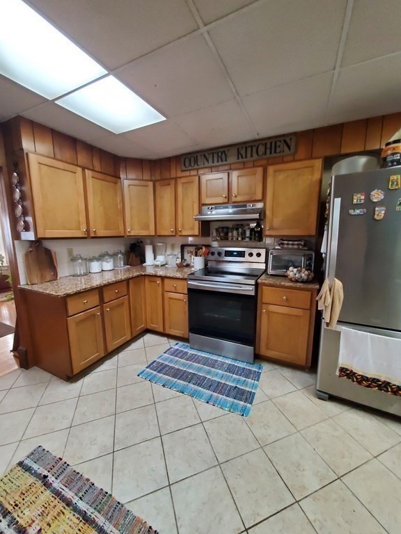 20 Baker Street Gardner, MA 01440 - Photo 6 of 15 a kitchen with stainless steel appliances granite countertop a stove sink and cabinets