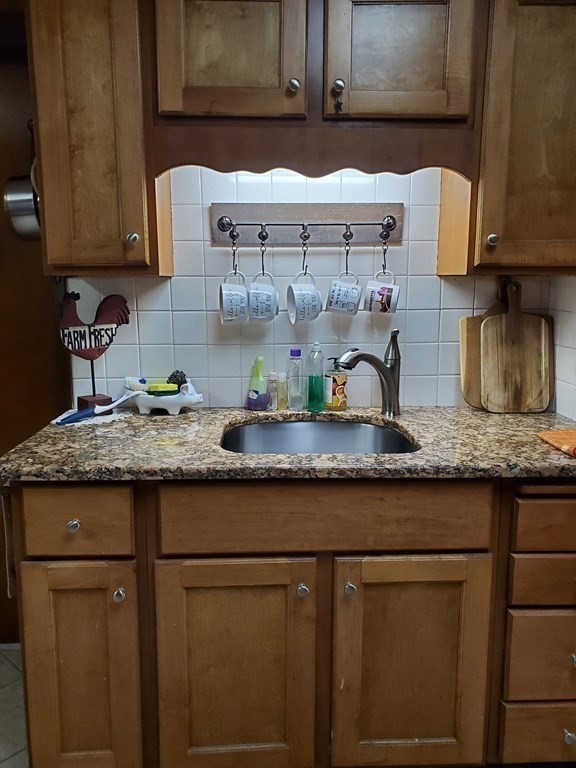 20 Baker Street Gardner, MA 01440 - Photo 7 of 15 a kitchen with granite countertop a sink a stove and cabinets