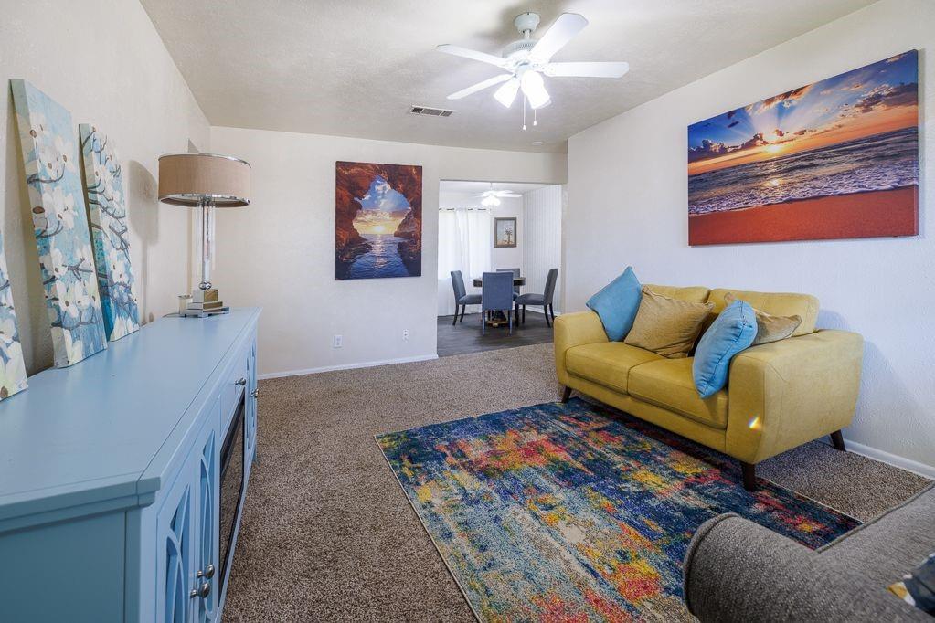 1723 Alhambra Street Dallas, TX 75217 - Photo 12 of 22 a living room with furniture and a rug