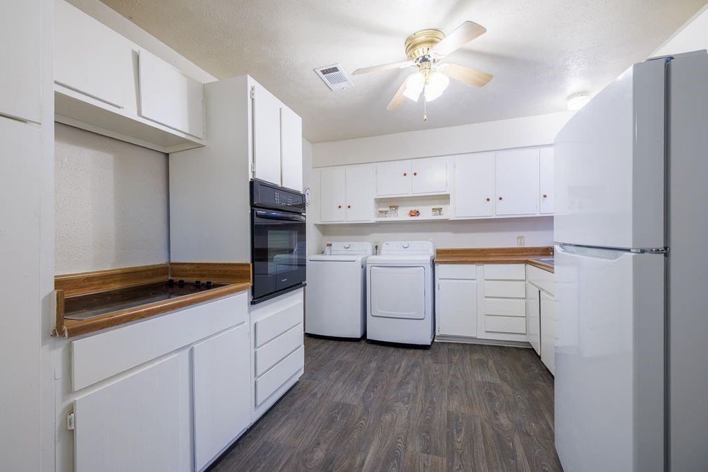 1723 Alhambra Street Dallas, TX 75217 - Photo 15 of 22 a kitchen with white cabinets stainless steel appliances and sink