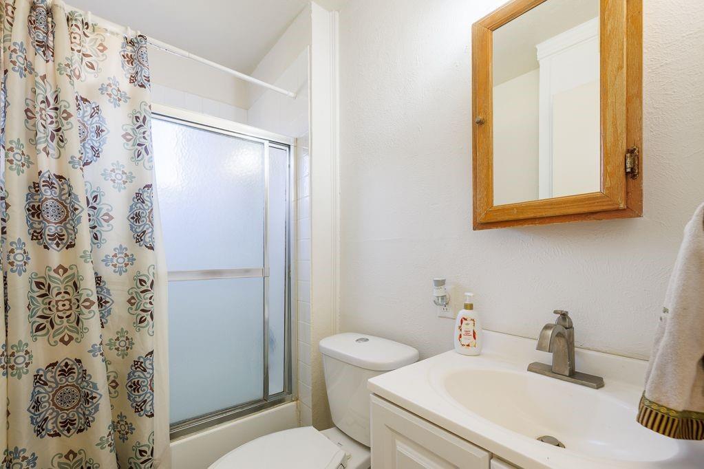 1723 Alhambra Street Dallas, TX 75217 - Photo 22 of 22 a bathroom with a toilet and a sink