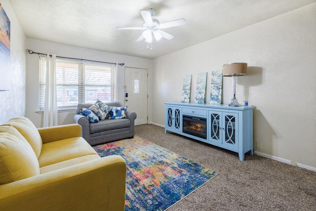 1723 Alhambra Street Dallas, TX 75217 - Photo 9 of 22 a living room with furniture and a fireplace
