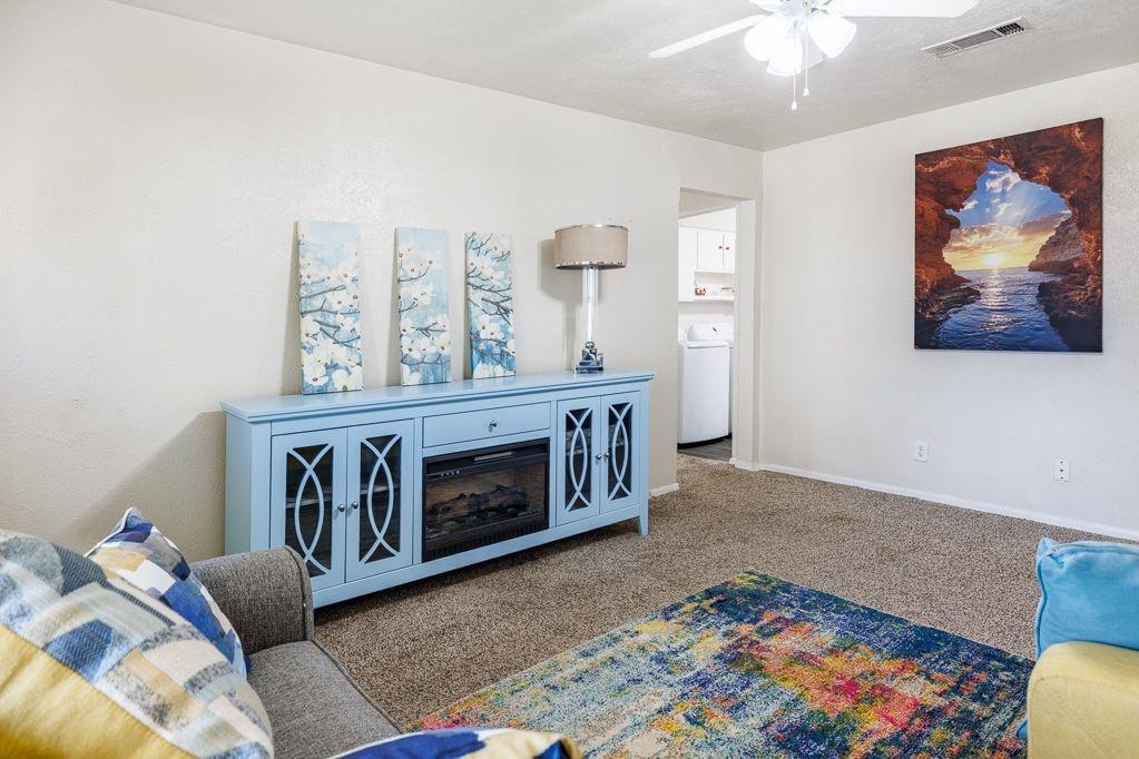 1723 Alhambra Street Dallas, TX 75217 - Photo 10 of 22 a living room with furniture and a baby crib