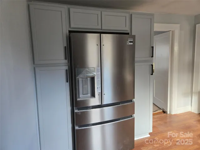 a metallic refrigerator freezer sitting in a kitchen