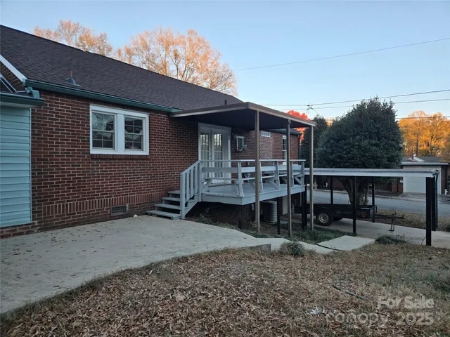 a backyard of a house with table and chairs