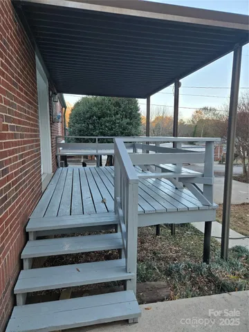 a view of backyard with wooden deck